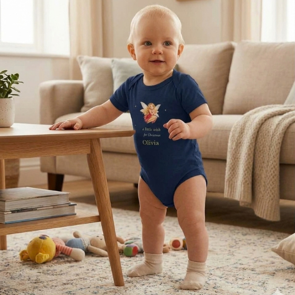 Navy baby bodysuit with a Christmas fairy and the name Olivia, worn by a smiling baby